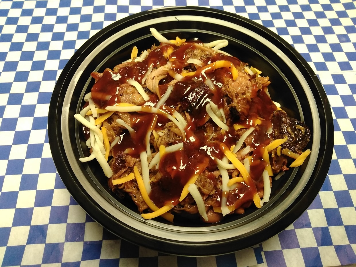 Choice of slow-smoked BBQ meat, seasoned rice as the base, pinto beans, shredded cheese and choice of BBQ sauce.