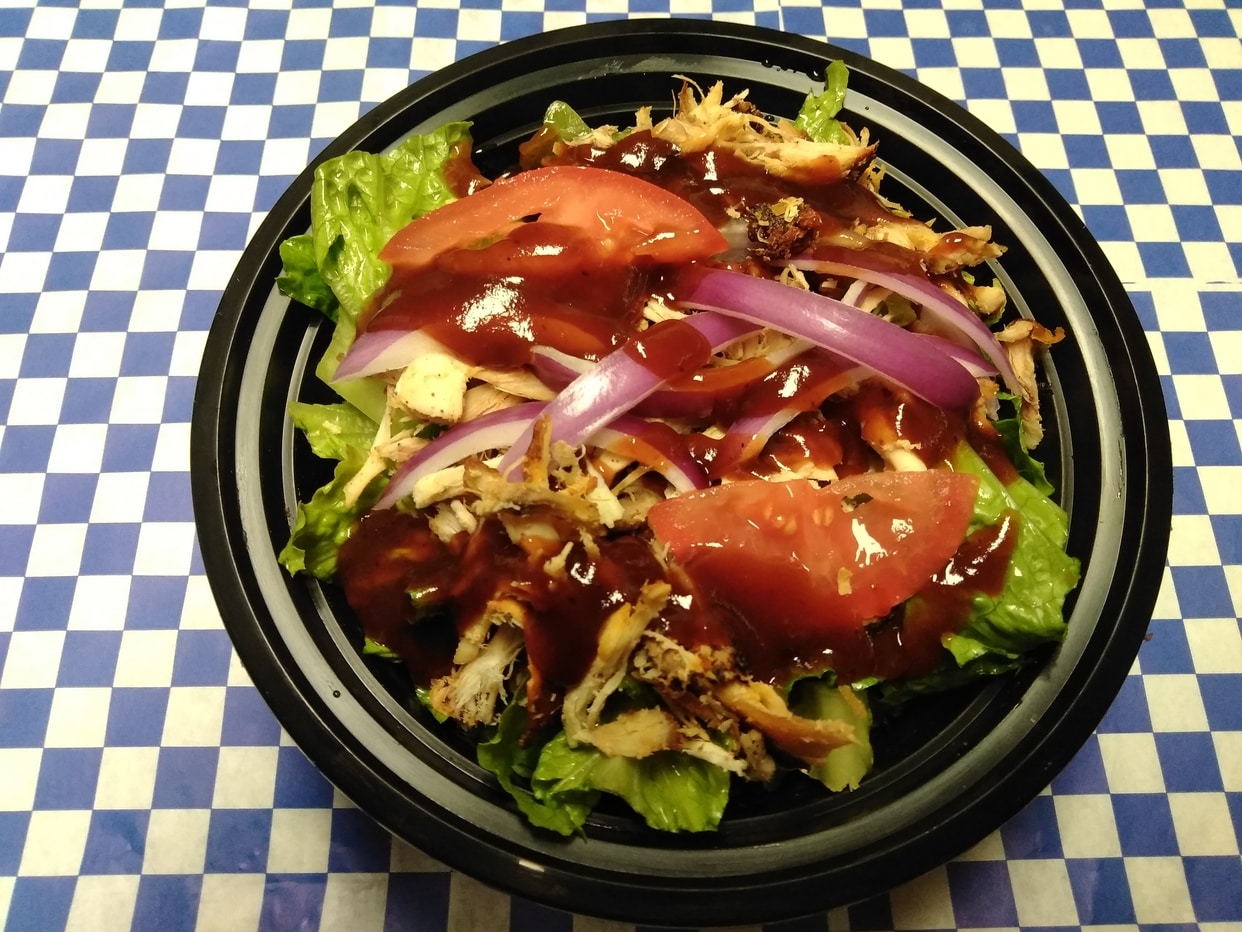 Choice of slow-smoked BBQ meat, seasoned rice as the base, pinto beans, romaine lettuce, onions, tomatoes and BBQ sauce.