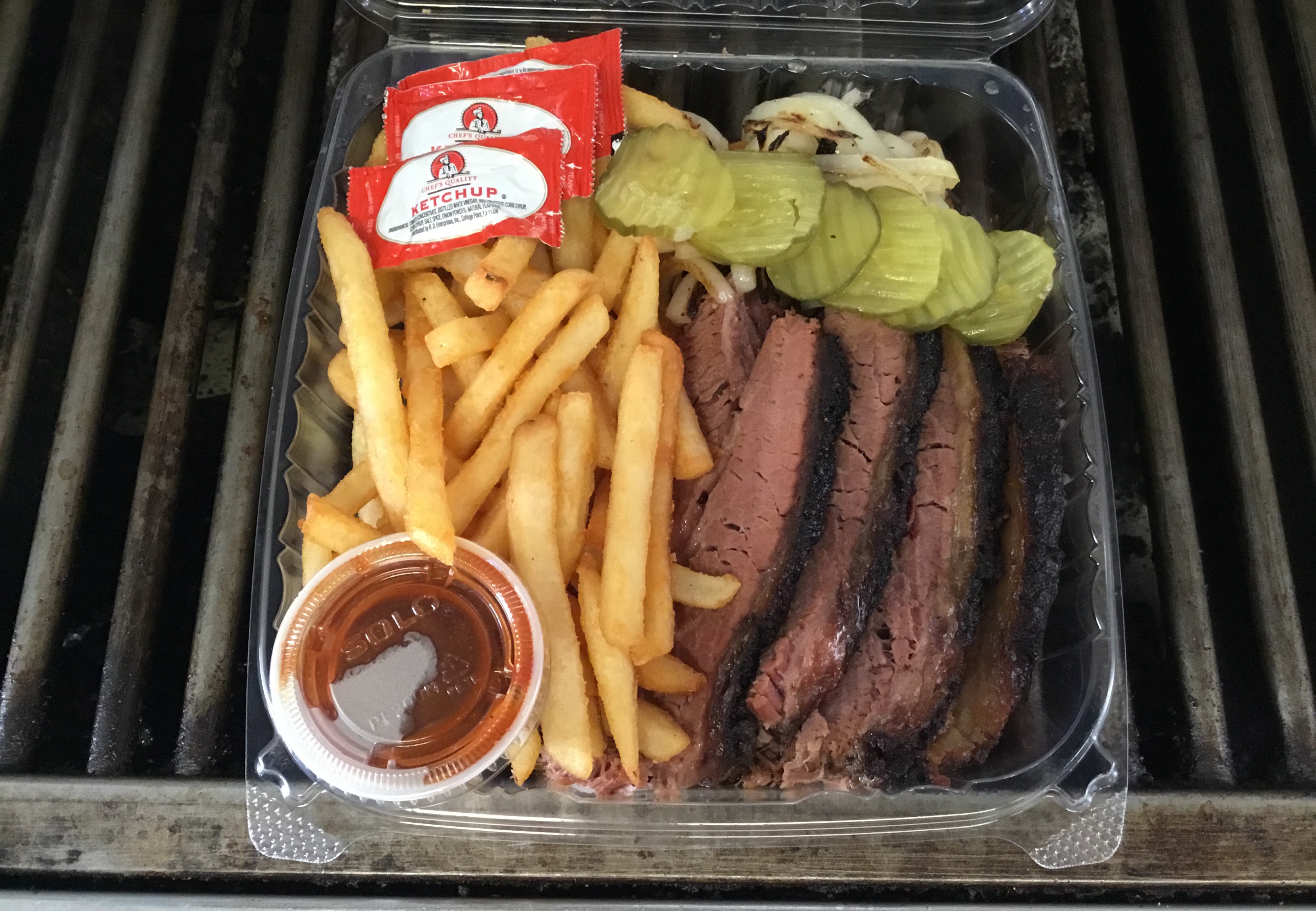 Slow smoked USDA Choice Angus Beef brisket served with sautéed onions, dill pickles, side of BBQ sauce and choice of coleslaw or fries.