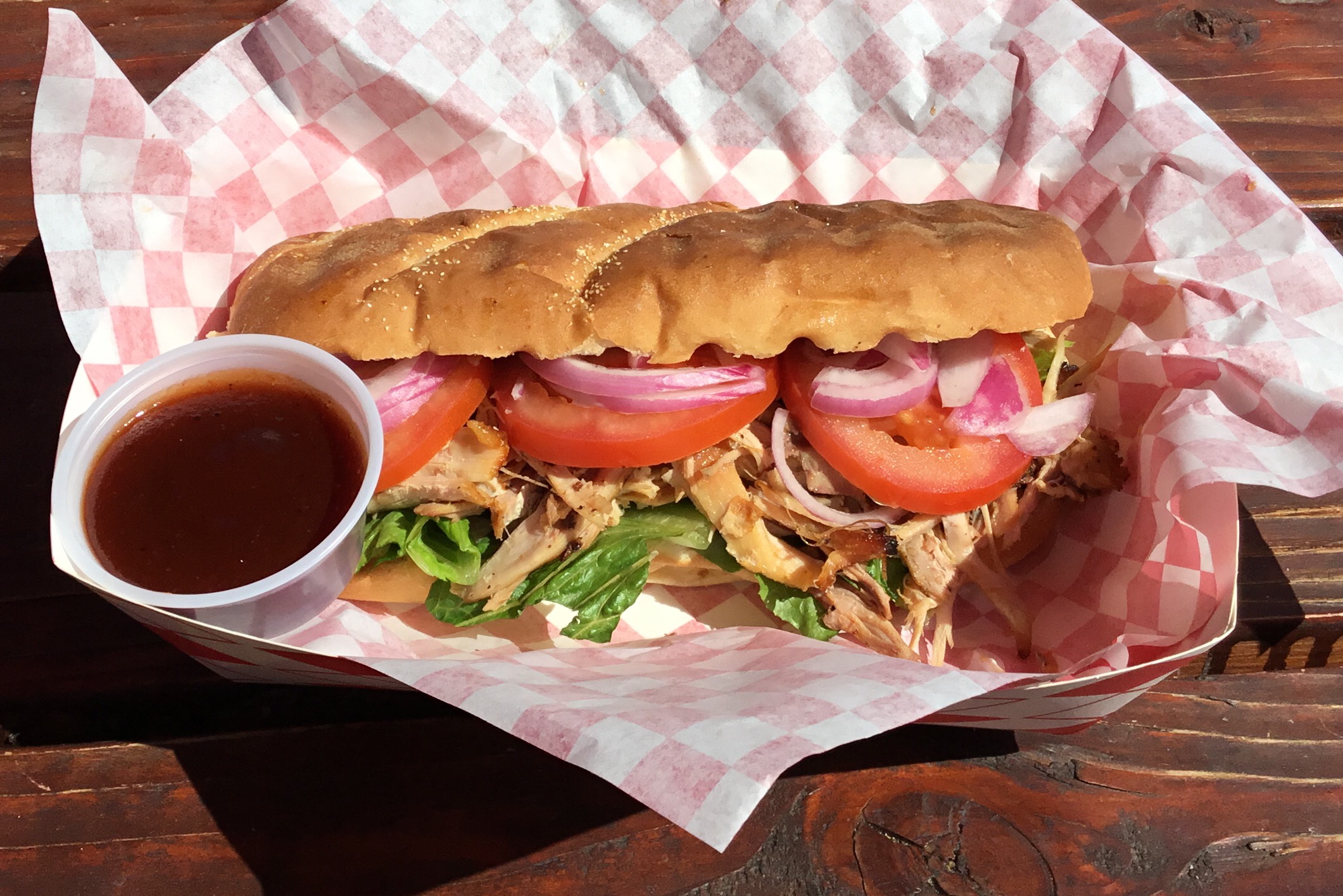 Pub Bun filled mayo chipotle sauce, lettuce, pulled chicken, onions, tomatoes and fries.