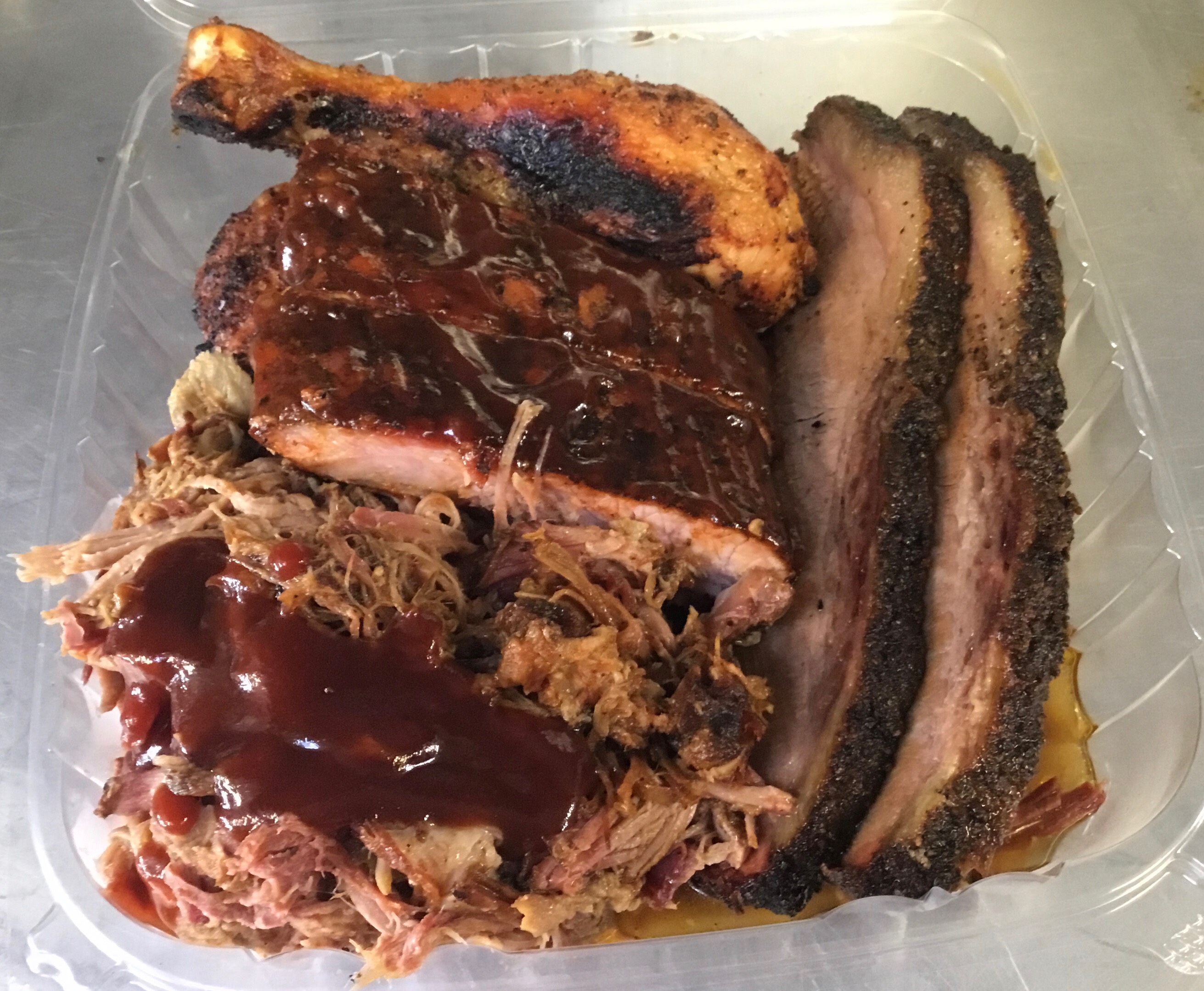 2 brisket slices, 2 ribs, 2 pieces of chicken, smoked pulled pork, regular fries and 2 regular sides.