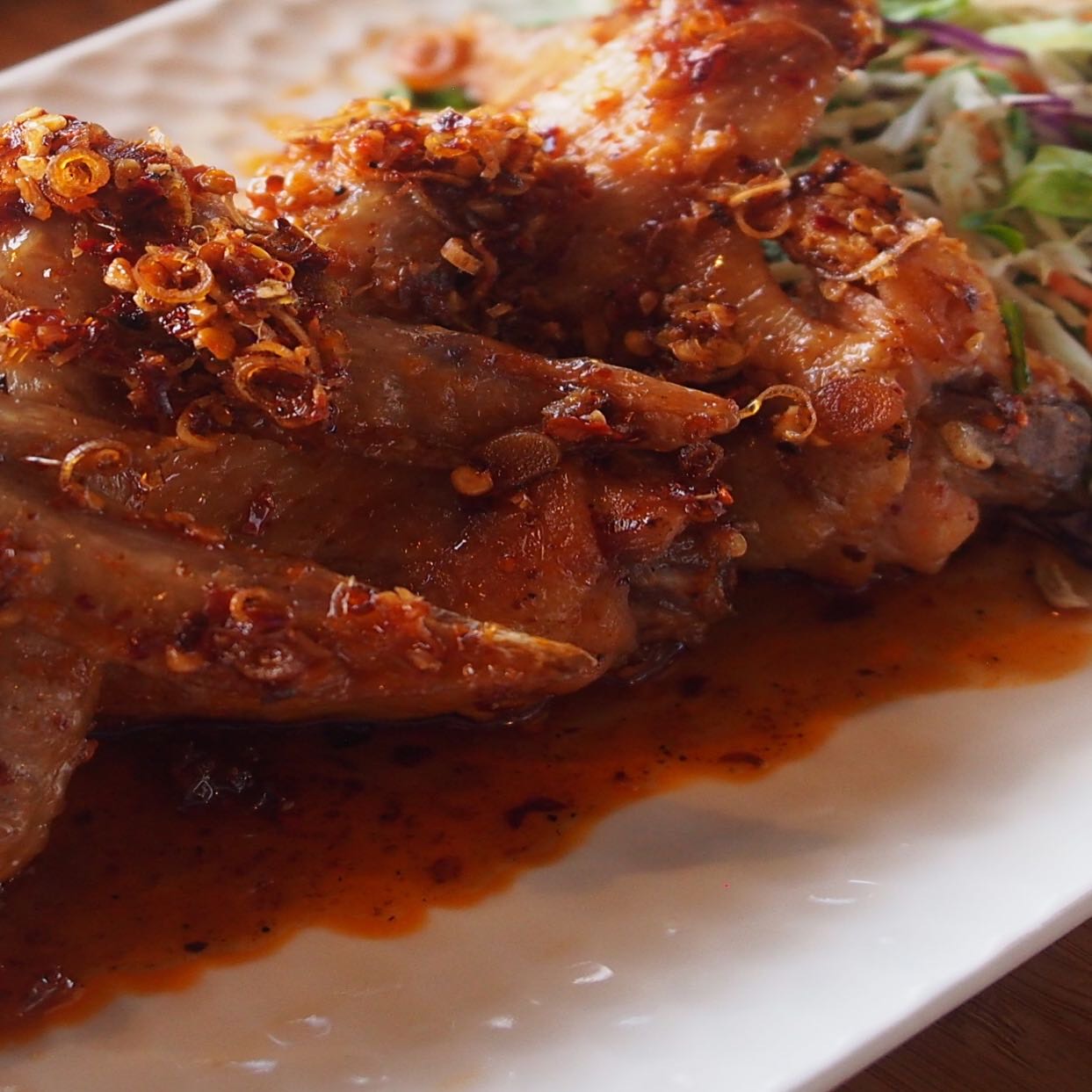 Crispy deep-fried chicken wings tossed in caramelized sweet chili fish sauce.