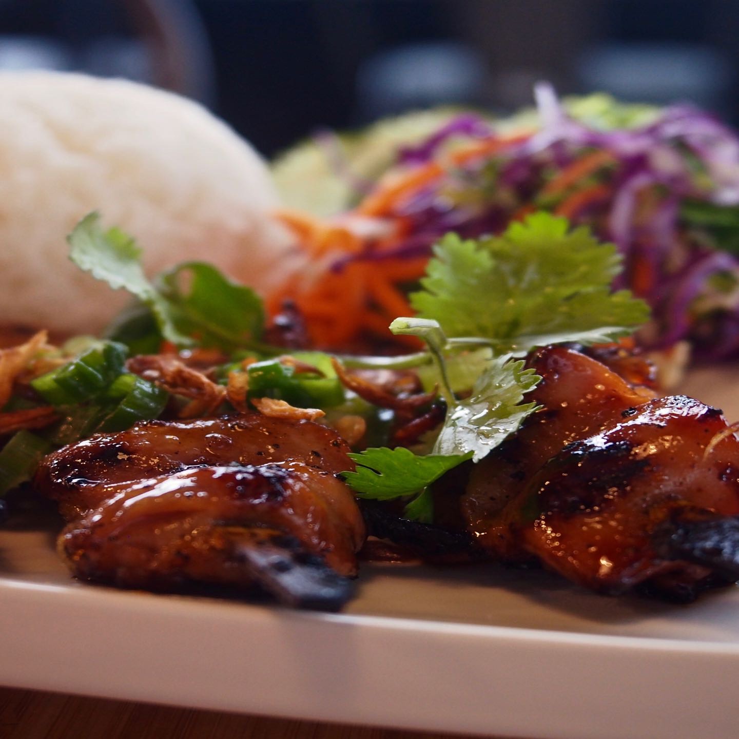 Grilled chicken filet marinated with savory honey and soy sauce. Your choice of vermicelli noodles or jasmine rice with lettuce, mixed greens, spring roll, shallots, roasted peanuts. Served with fish sauce dressing or vegetarian dressing.