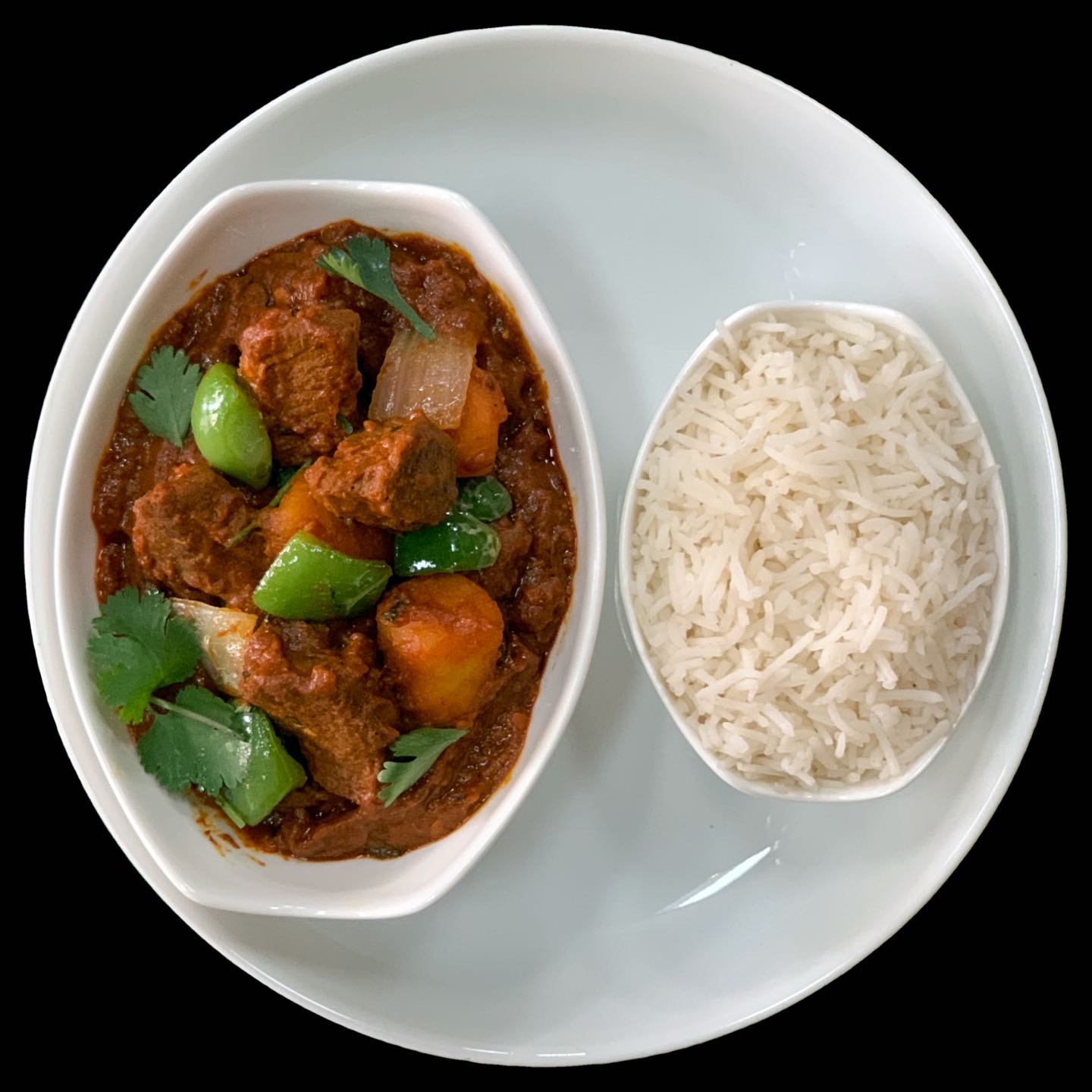 Braised lamb seasoned with bold flavors from spices like dried chiles, peppercorns, cardamom, cloves, etc., along with vegetables like bell peppers.