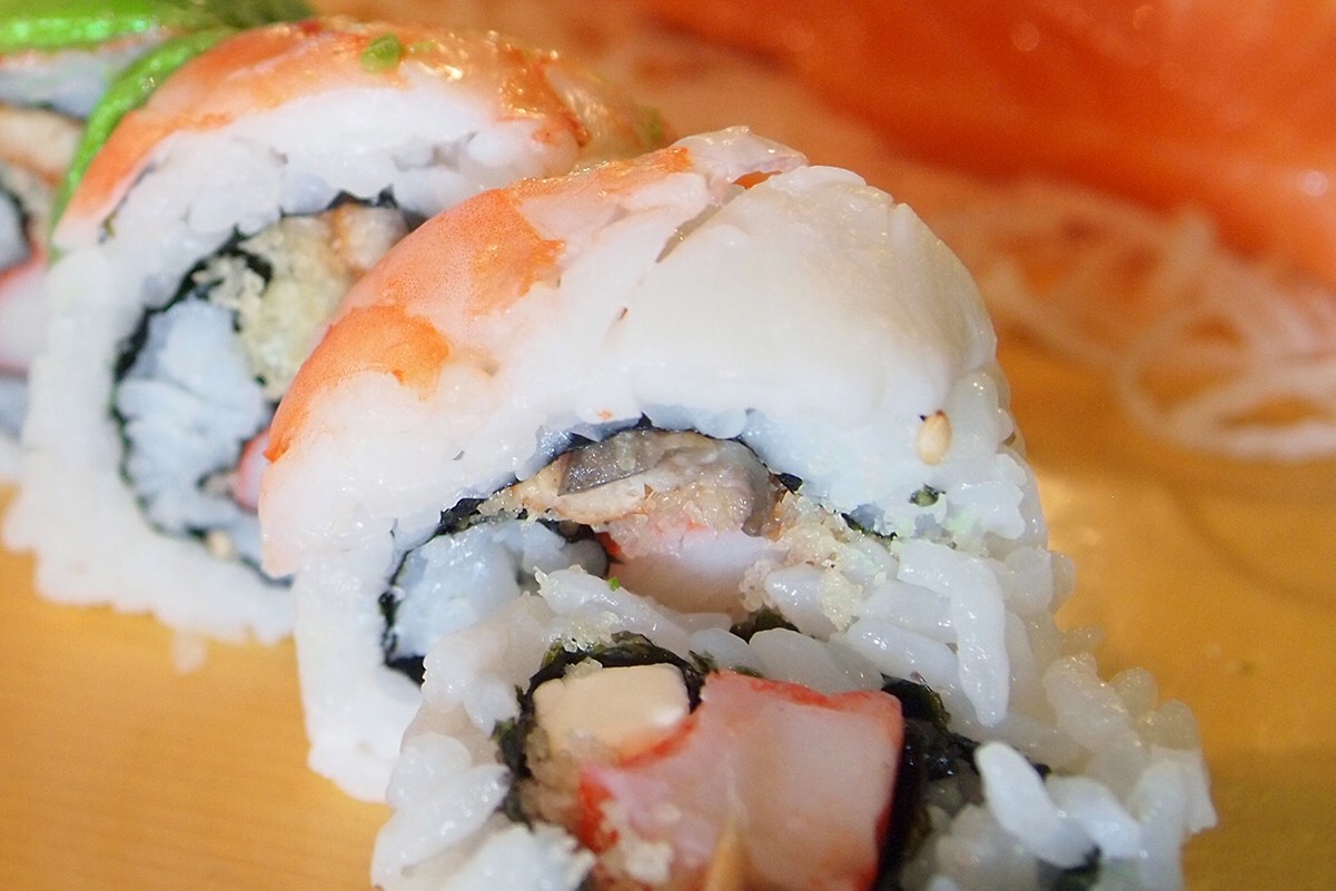 Unagi, krab, cucumber, cream cheese, and tempura crunch roll covered with shrimp and avocado