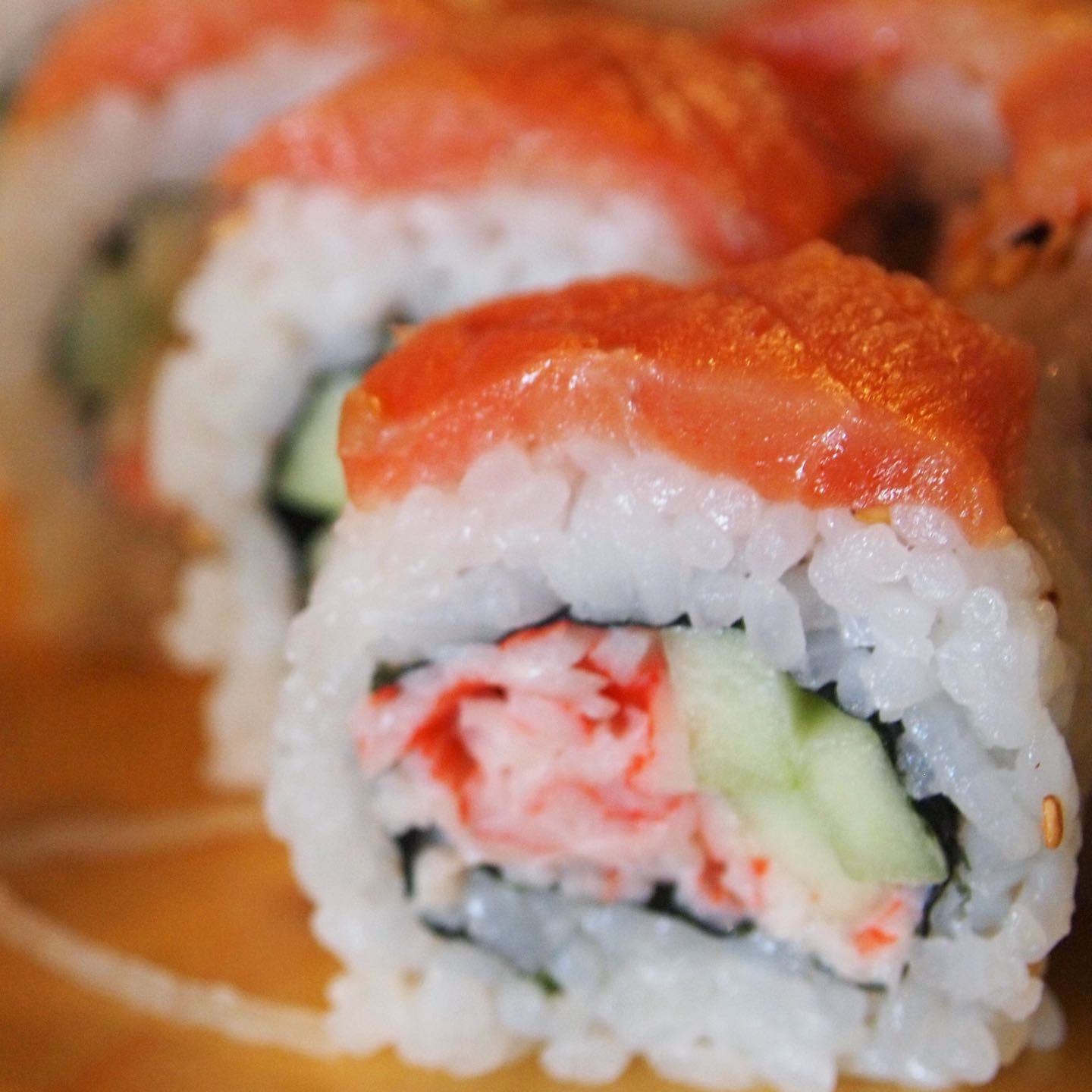 Krab salad roll topped with smoked salmon and a swirl of our sweet sauce
