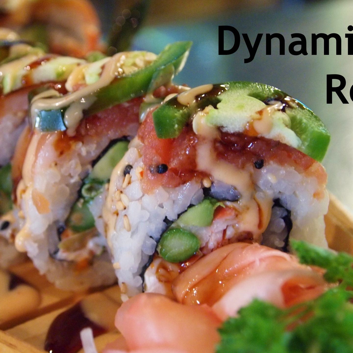 A seafood salad, asparagus, avocado and cream cheese roll spiced with jalapeño, spicy tuna and salmon on top; sweet and spicy sauce