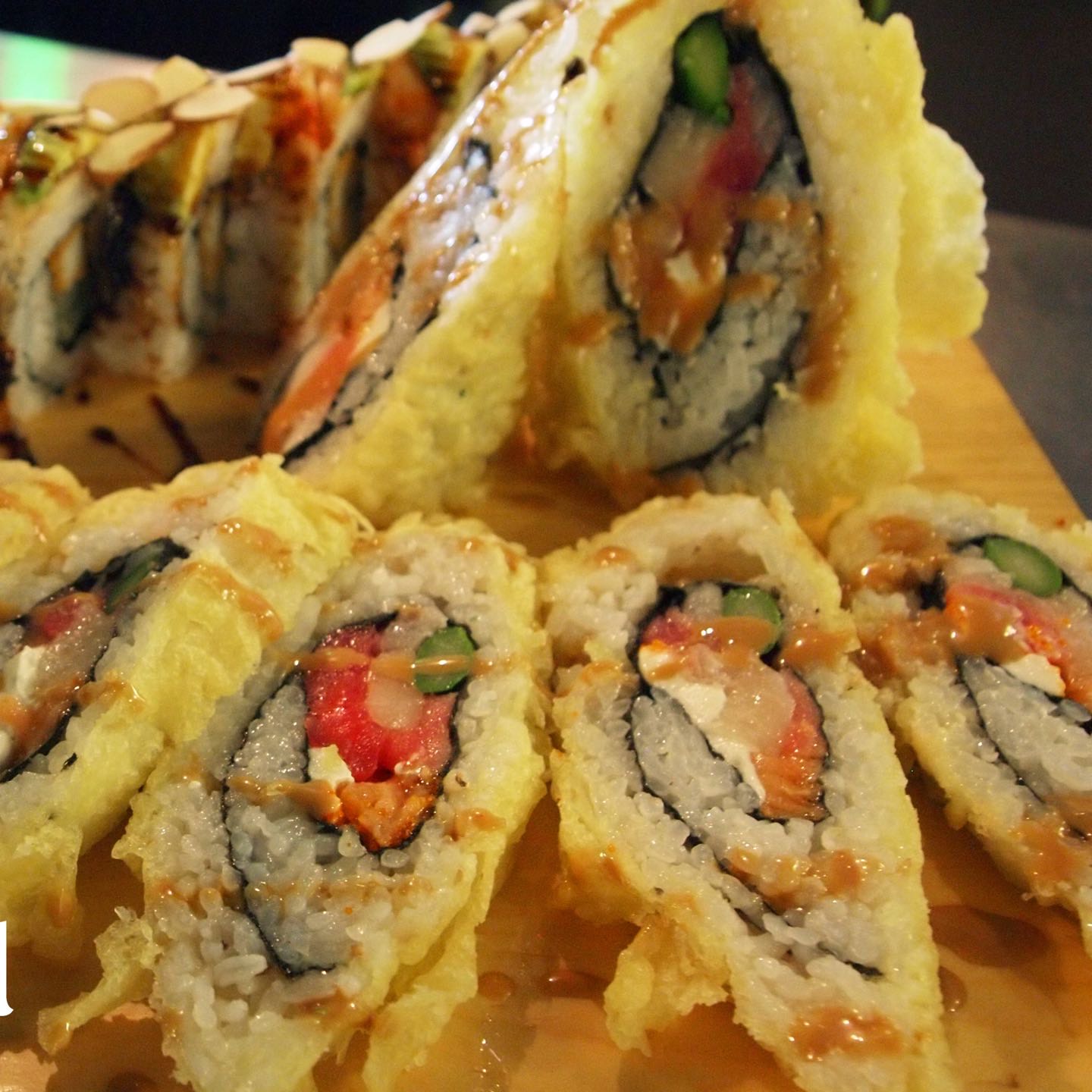 This tempura fried roll has a fantastic assortment of maguro, escolar, tai, salmon, masago, asparagus and cream cheese