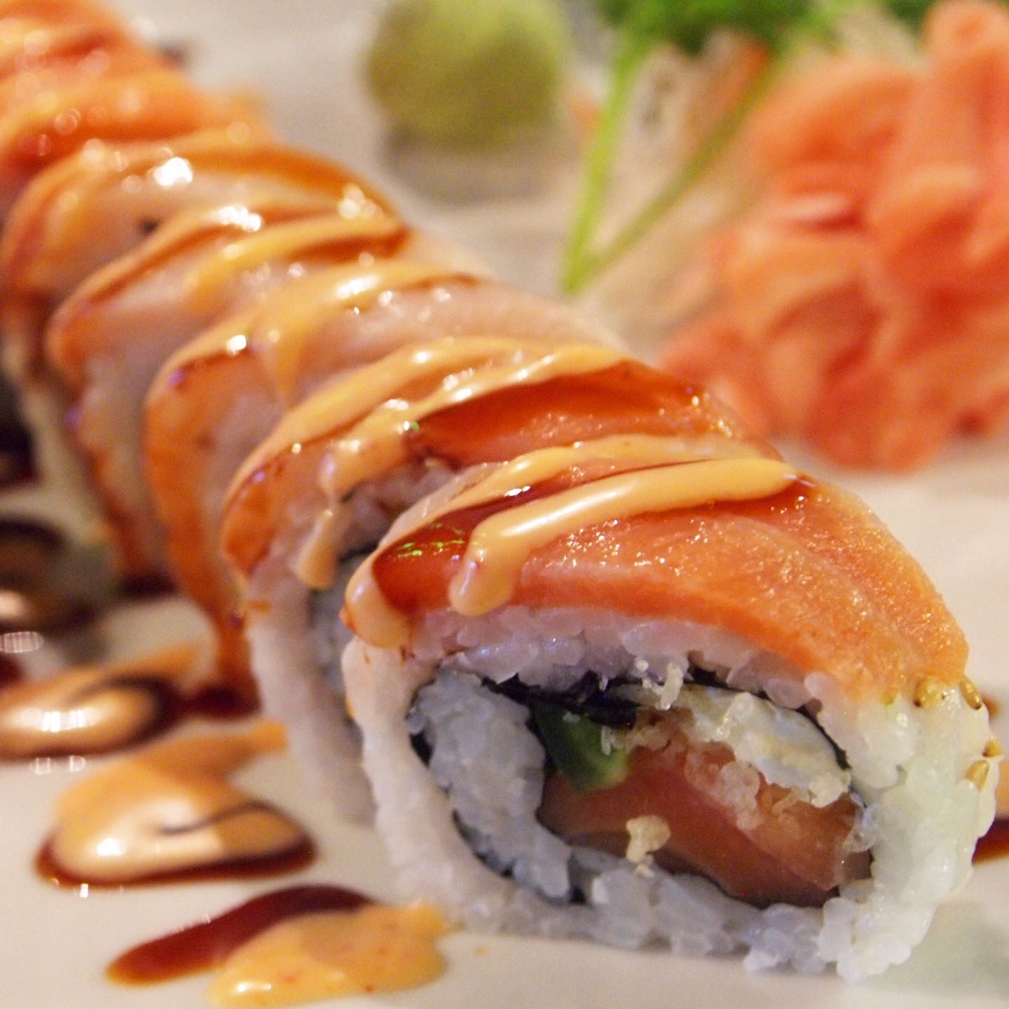 Salmon, tempura crunch, avocado, jalapeño, cream cheese on the inside. Smoked salmon and hamachi on the outside; sweet & spicy sauce