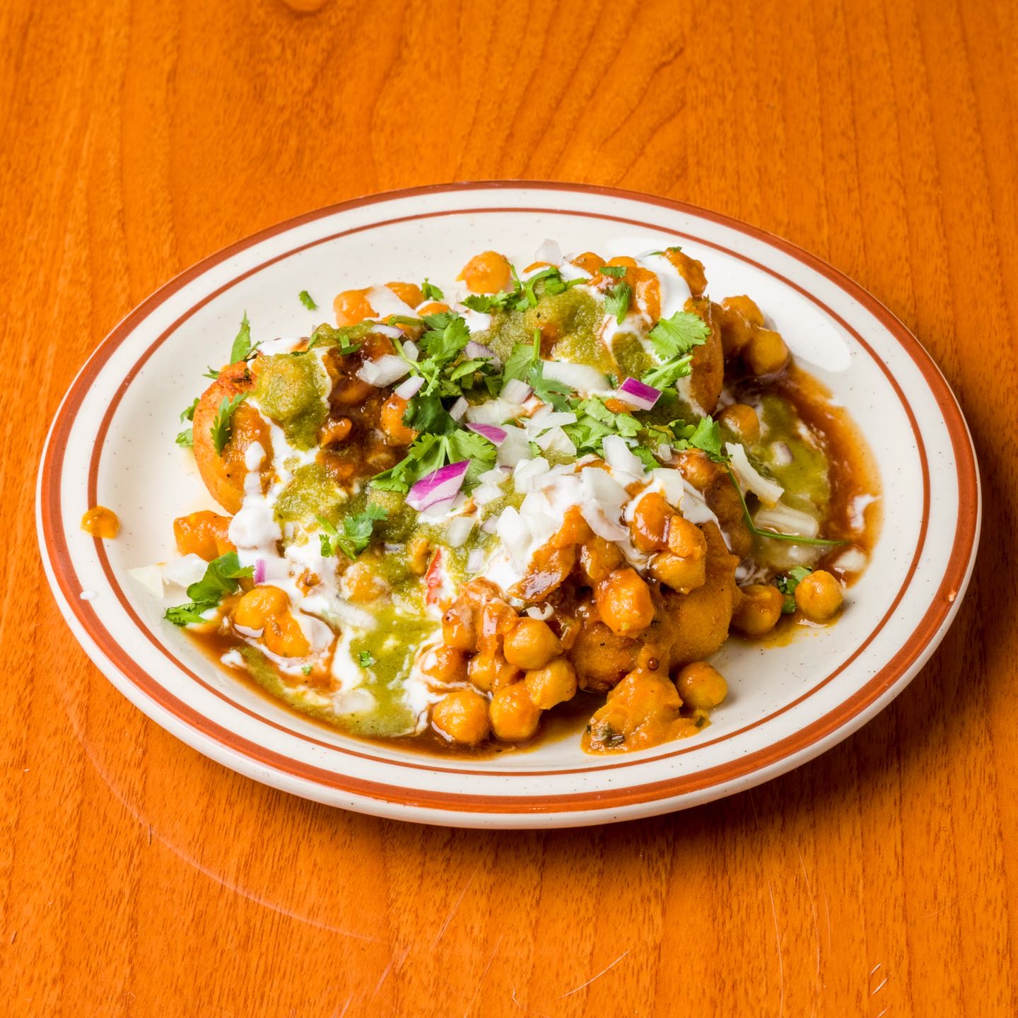 Potato patty and chole mixed with yogurt, tamarind and mint sauce.
