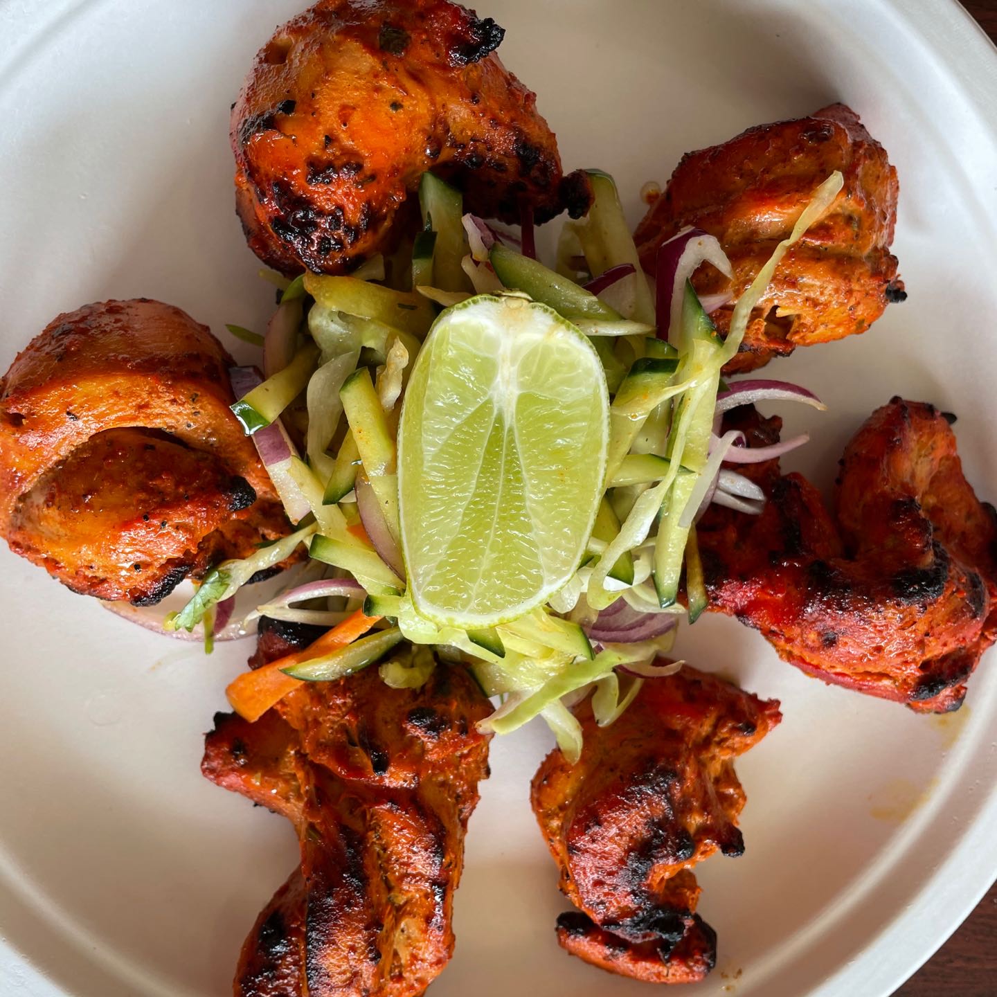 Marinated in yogurt along with lime juice and aromatic spices, then threaded onto skewers and cooked in tandoor (clay oven).