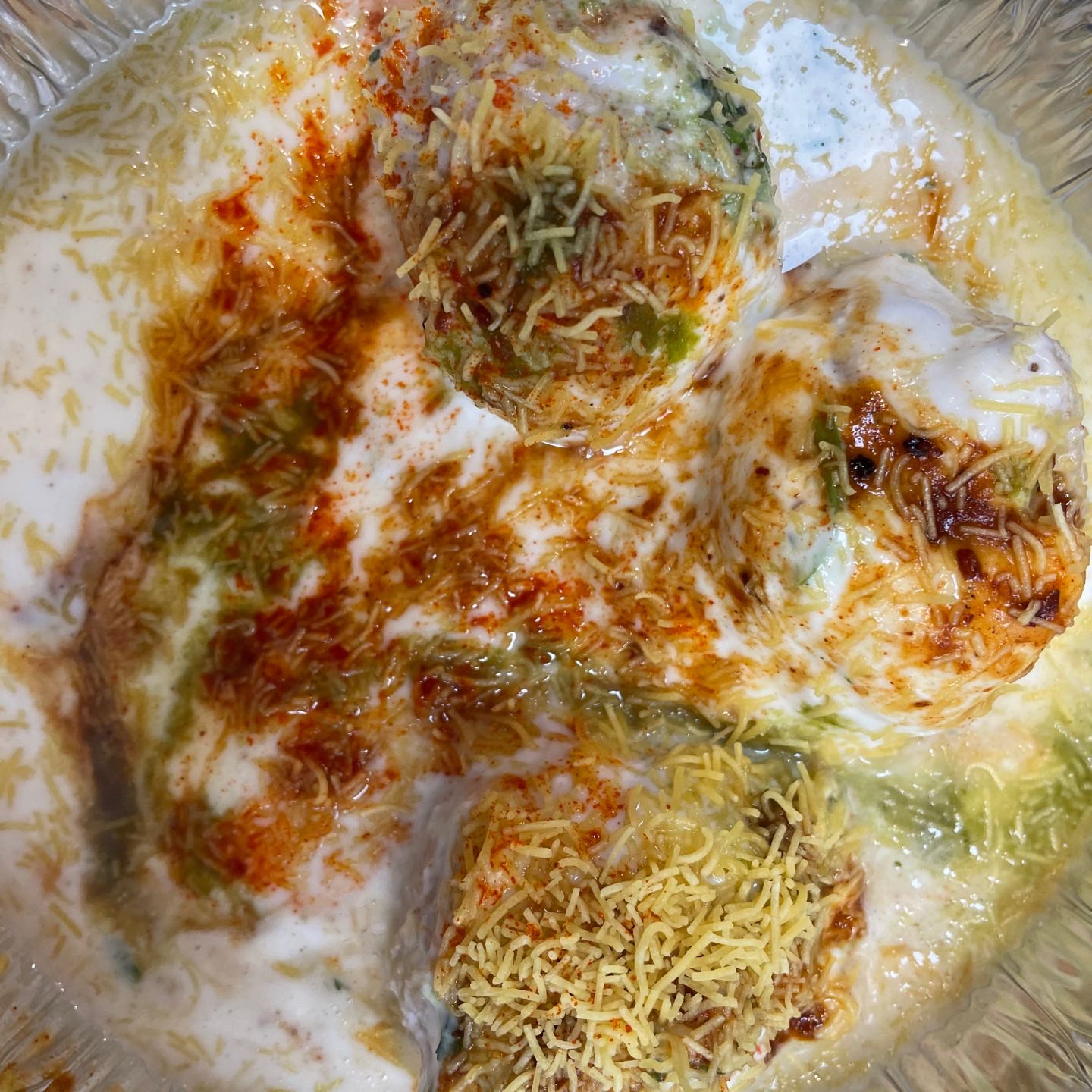 Dahi Vada is a popular street food from North India. Dahi means yogurt and Vada means deep fried fritters or dumplings.
