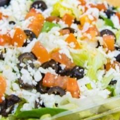 Spinach, Feta, olives, tomatoes, chopped garlic & Mozzarella cheese on a fresh bed of Iceberg & Leaf.