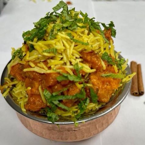 Juicy lamb pieces infused with aromatic spices, nestled in fragrant basmati rice, offering a delectable symphony of flavors in every bite. Served with raita.