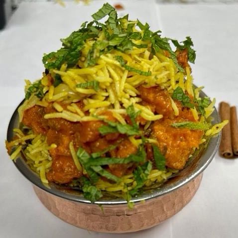 Tender goat meat marinated in a blend of spices, layered with aromatic basmati rice, creating a mouthwatering fusion of textures and flavors. Served with raita.