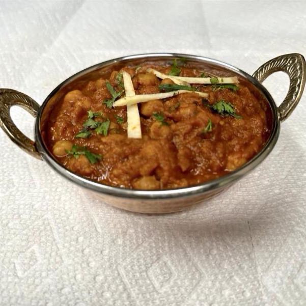 A flavourful curry made with chickpeas cooked in a tangy tomato- based sauce, seasoned with spices and herbs.