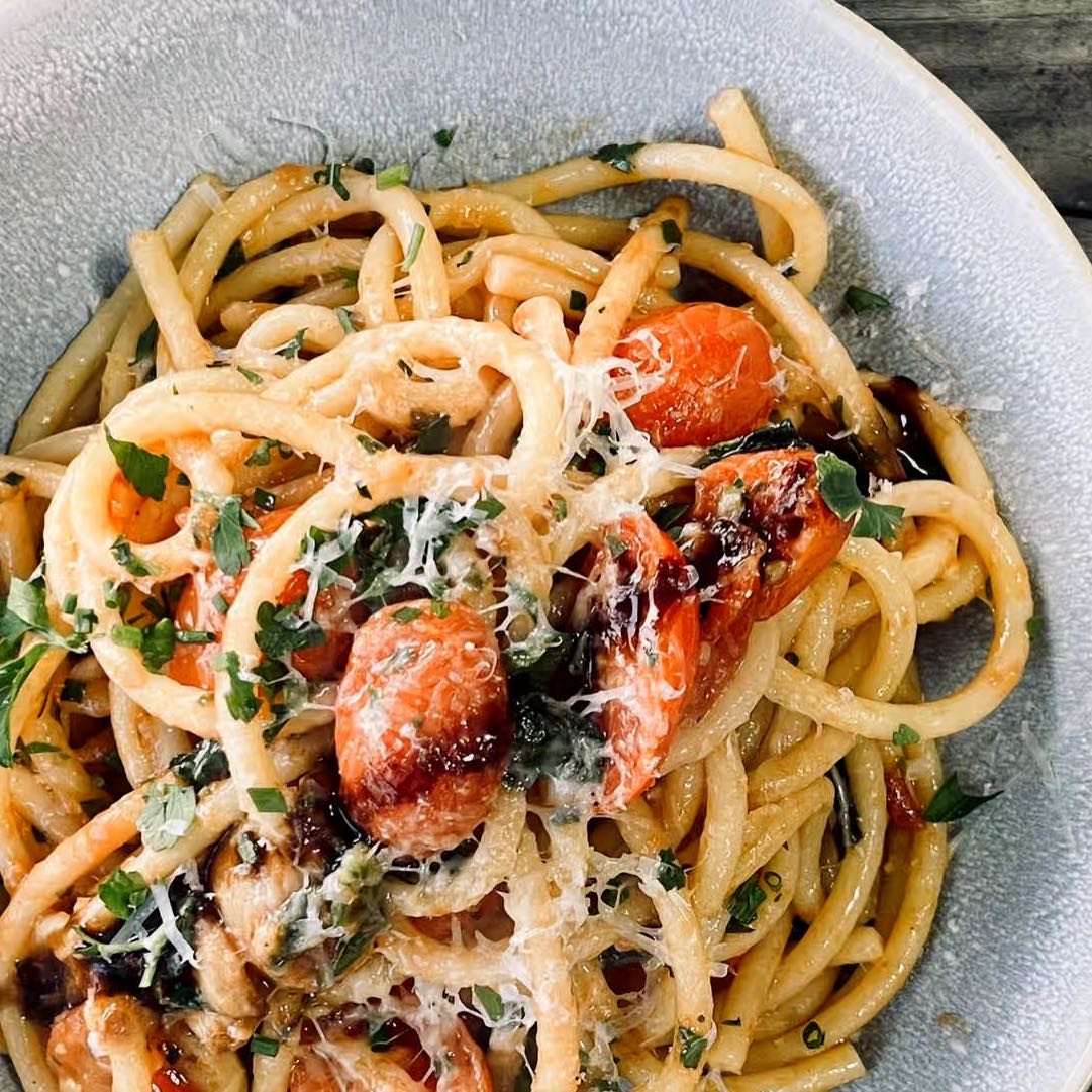 Long pasta sauteed with fresh garlic, blistered tomatoes, torn basil, fin herbs, and reggiano.