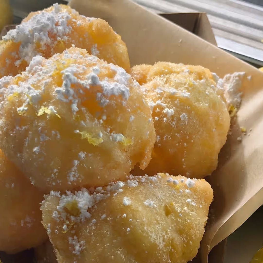 Crispy Italian donuts, glaze, seasonal fruit sauce