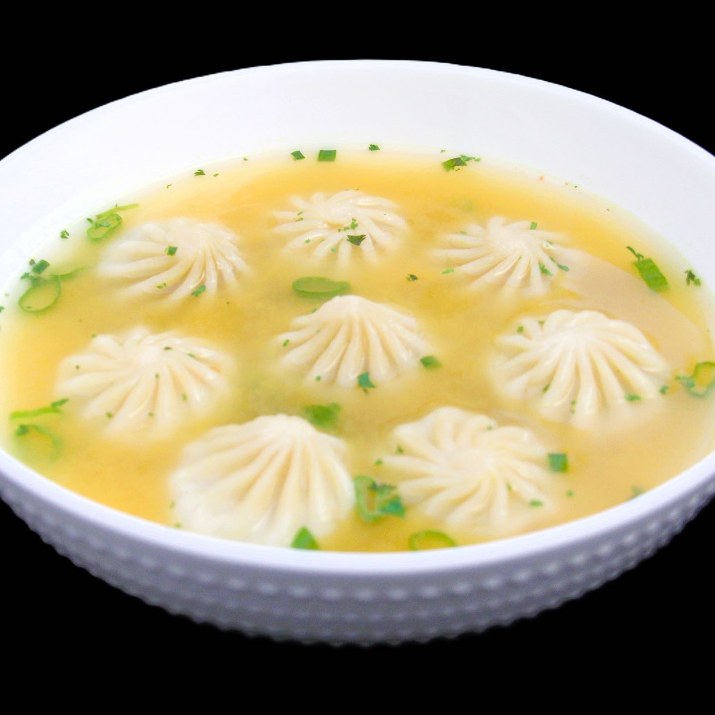 Steamed Nepali momo made from scratch, filled with a delectable mixture of vegetable protein or ground chicken blended with vegetables and aromatic Himalayan spices dipped in clear soup. Served with sauce.