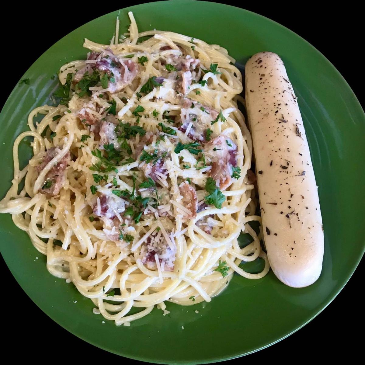 Al dente linguine noodles tossed in a light creamy garlic sauce with bacon.  Served with an Italian bread stick. - Spaghett-About It restaurant in Forest Grove, OR