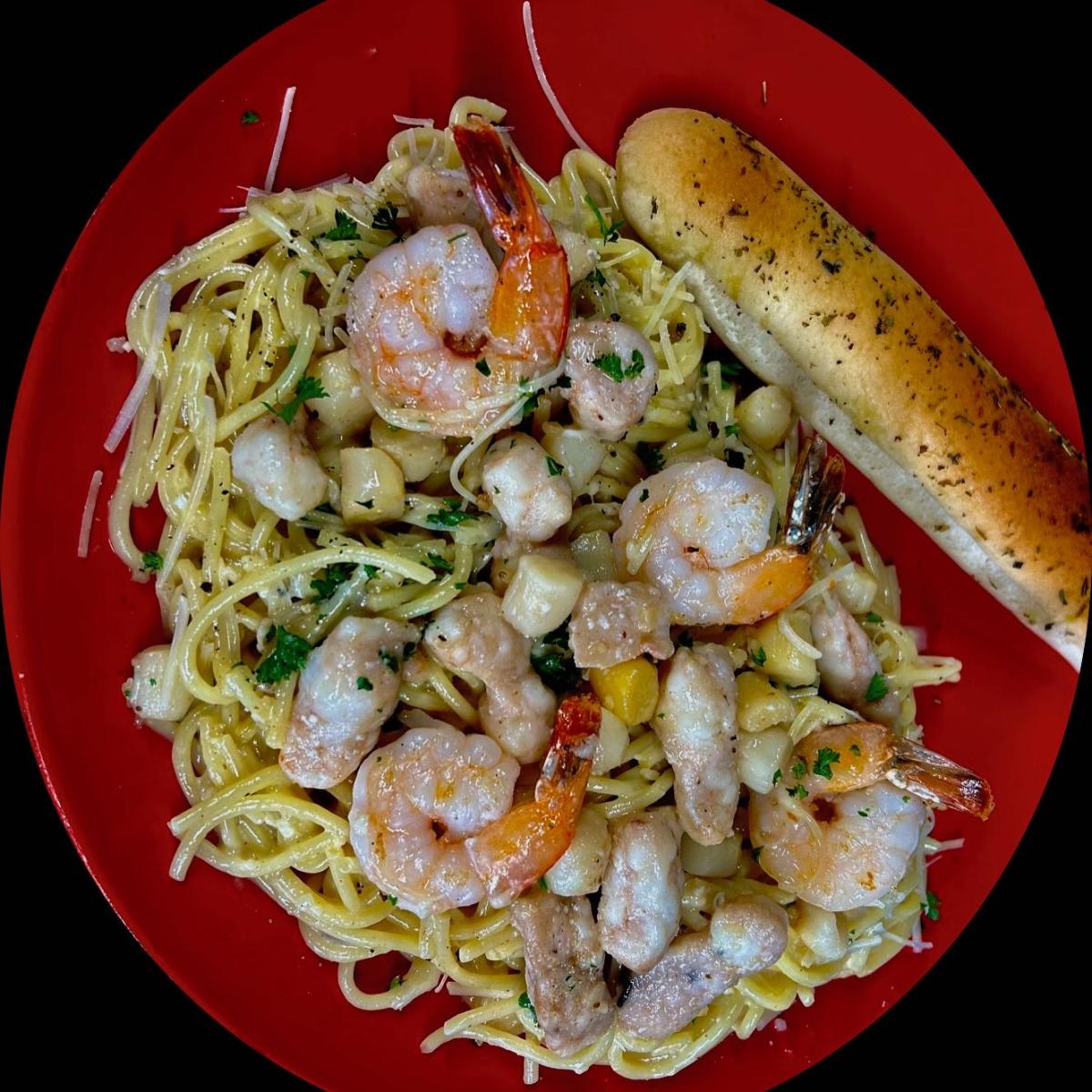 Lobster, scallops & shrimp served over al dente linguine noodles tossed in a  creamy pesto garlic sauce. - Spaghett-About It restaurant in Hillsboro, OR