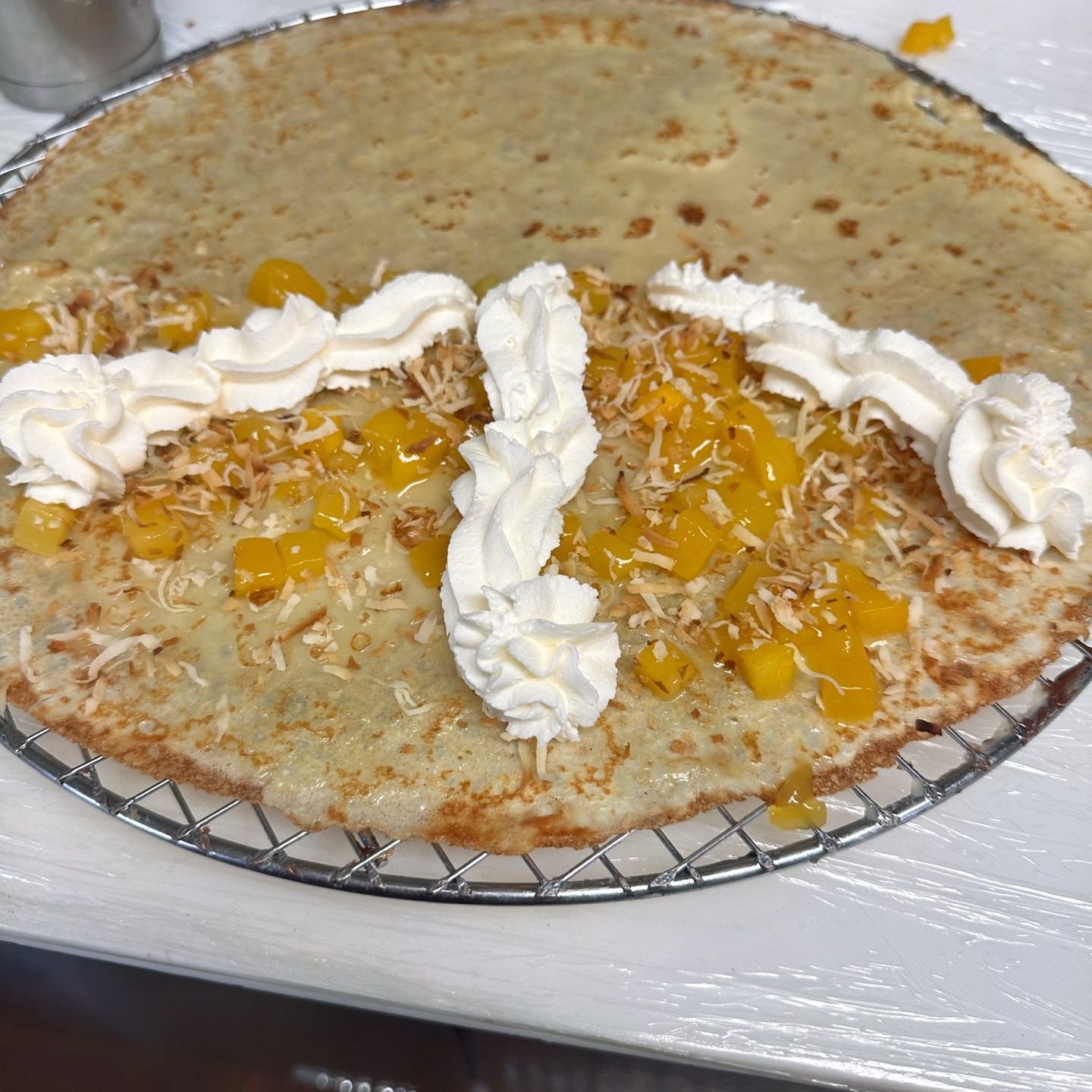 Homemade mango compote, toasted coconut flakes & whipped cream.