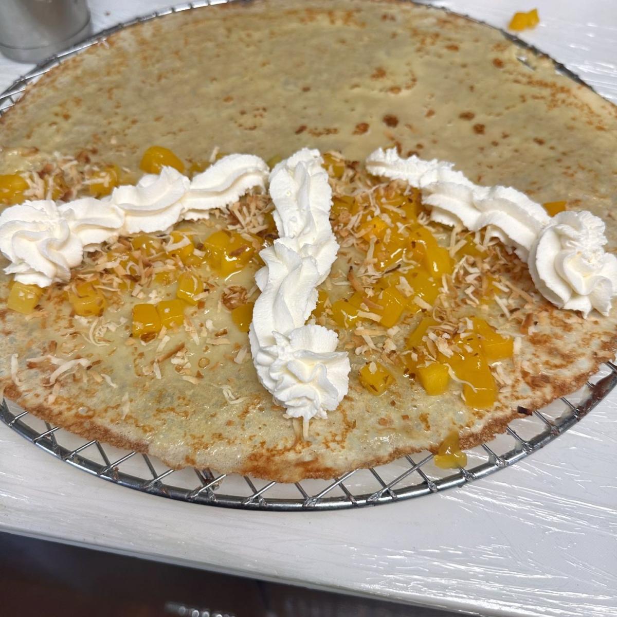 Homemade mango compote, toasted coconut flakes & whipped cream. - Oh My Crepe restaurant in Hillsboro, OR