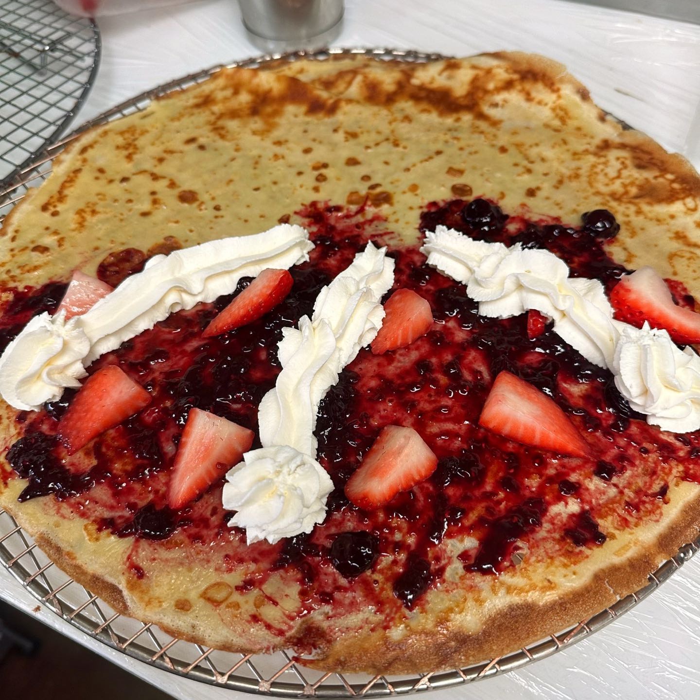 Homemade mixed berry compote, fresh strawberry & whipped cream.