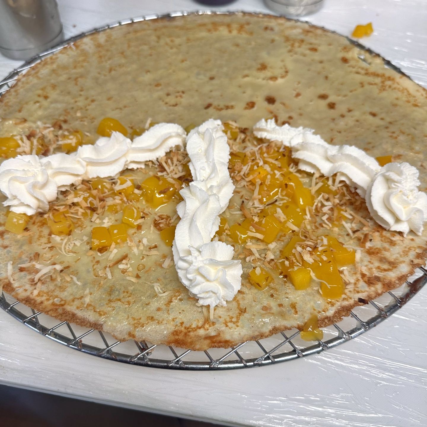 Homemade mango compote, toasted coconut flakes & whipped cream.