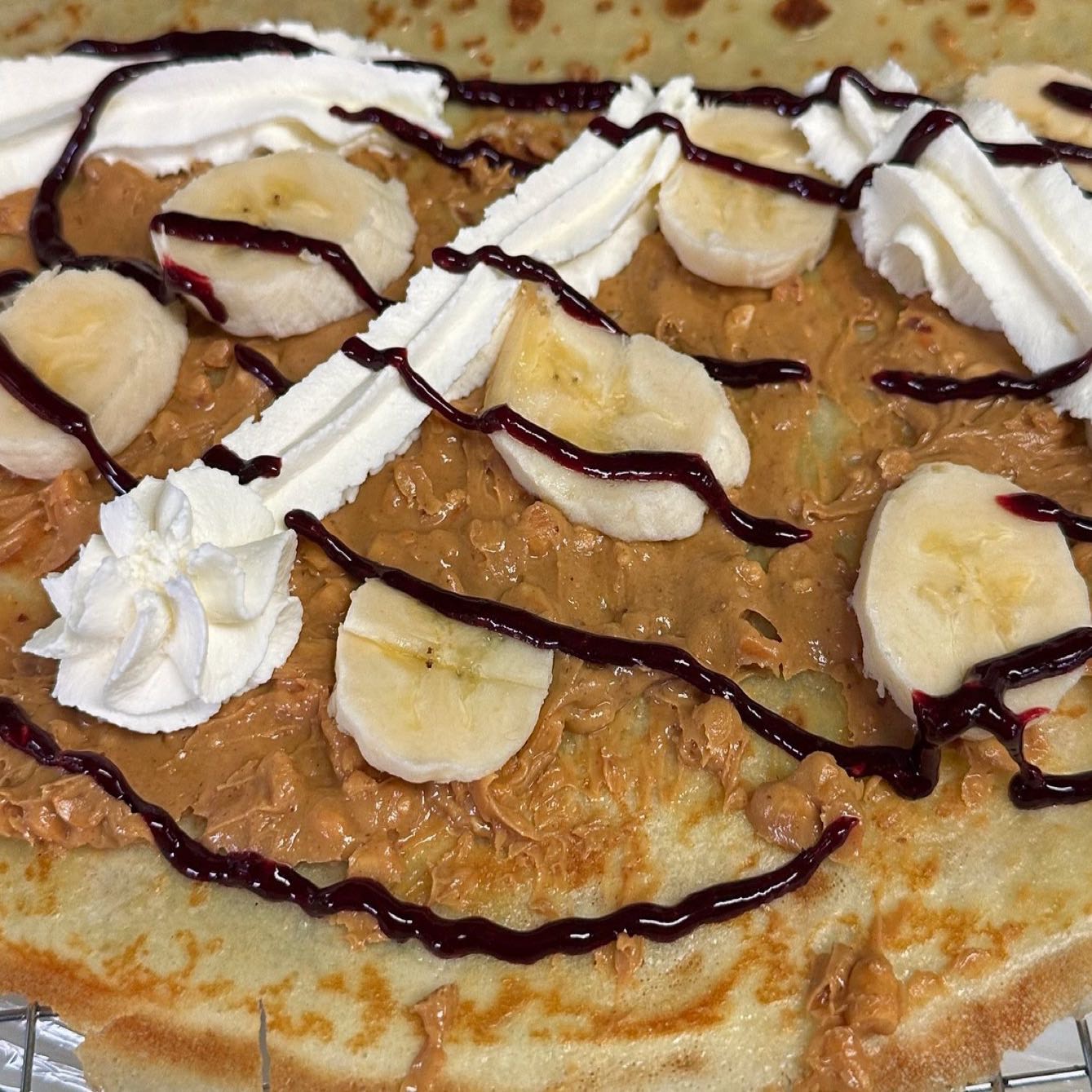 Crunchy peanut butter, banana, mixed berry sauce & whipped cream.