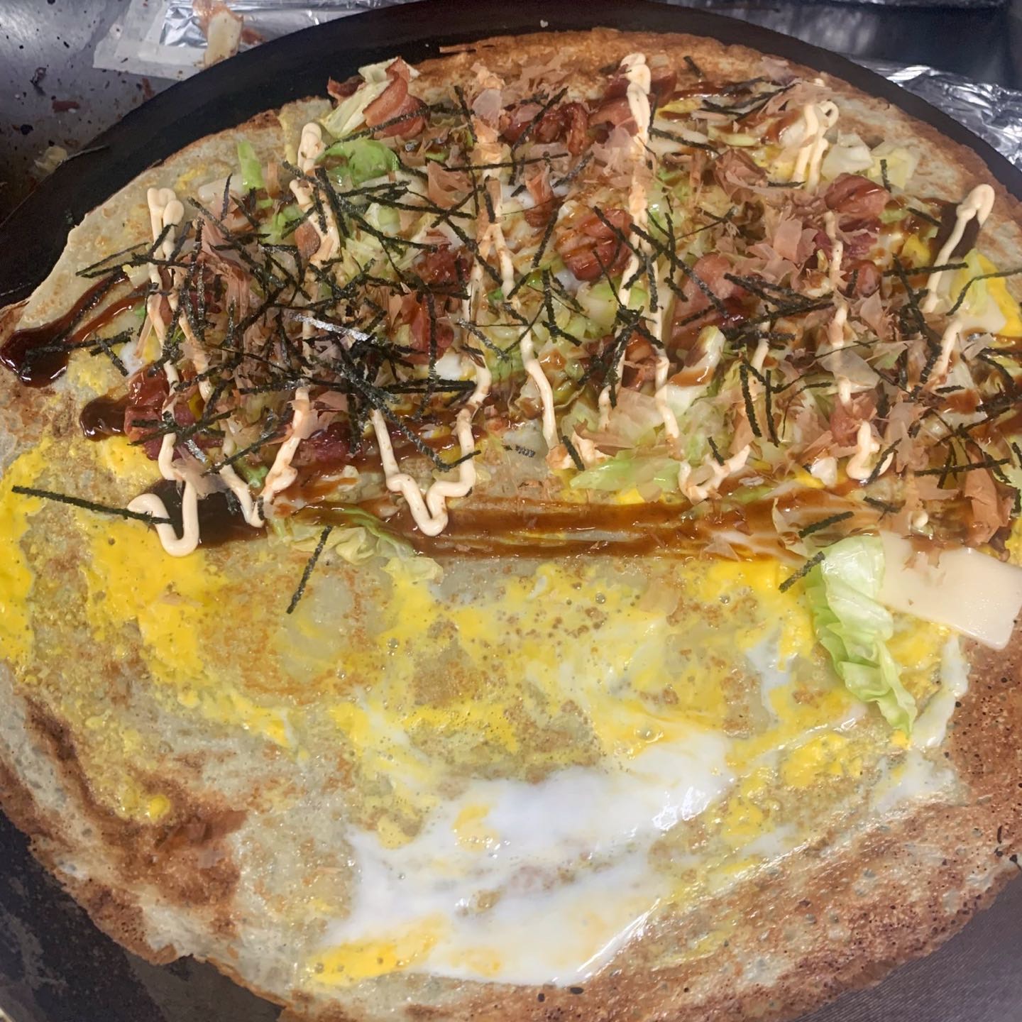 Sauteed cabbage, bacon, egg, swiss cheese, bonito flakes, nori, okonomiyaki sauce & Japanese mayo.