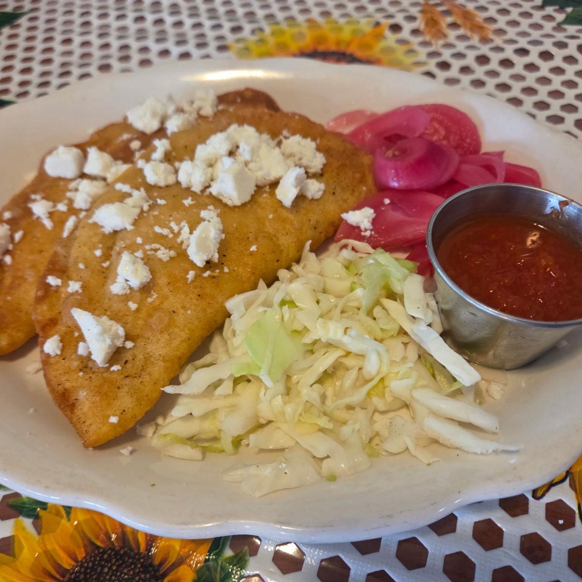 Handmade organic corn tortilla, lightly fried, filled with cheese & choice of meat, topped with queso fresco, red pickled onions, house tomato salsa & cabbage. - Lindo Yucatan restaurant in Portland, OR