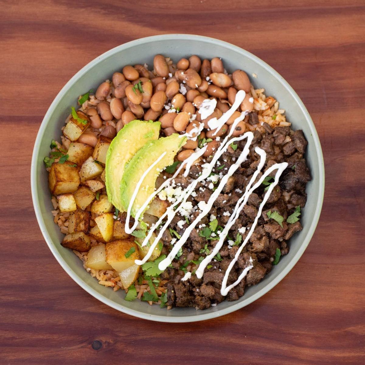 Slow-cooked tender beef roast (non-spicy), served over Mexican rice and topped with avocado, cilantro, Mexican sour cream, Mexican cheese and oven-baked potatoes.  Optional egg add-on. - Chorizo Hub restaurant in Beaverton, OR