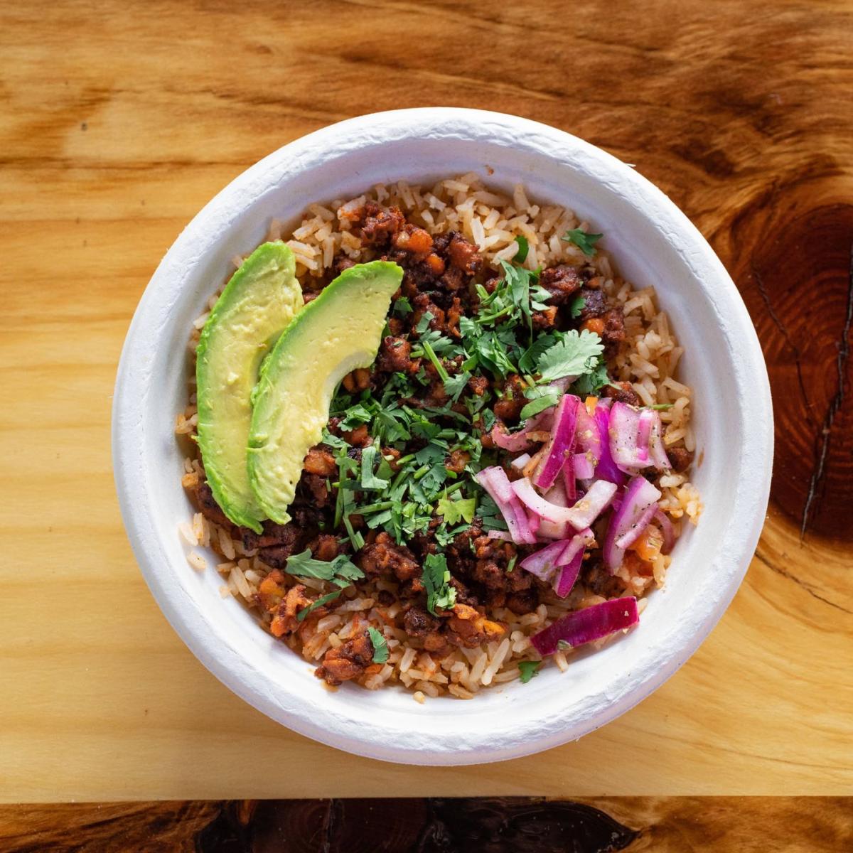 Your choice of organic tempeh served over Mexican rice and topped with fresh cilantro, avocado, corn, beans, pickled onions and vegan sour cream. - Chorizo Hub restaurant in Beaverton, OR