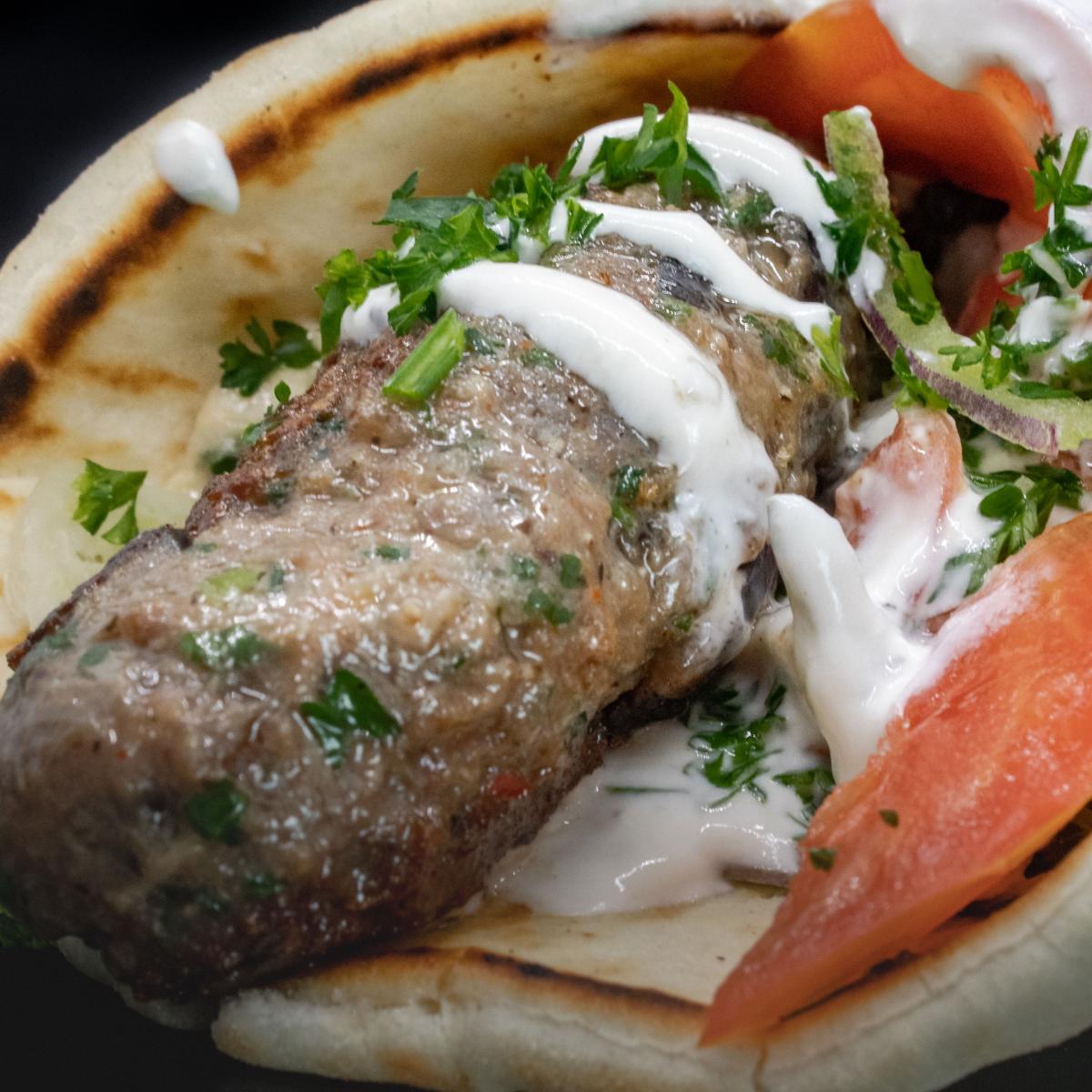 Grilled skewers of gound been served in pita bread with lettuce, parsley, onion and tomato.  Your choice of tzatziki or tahini sauce. - Aybla Grill restaurant in Beaverton, OR